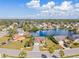 Charming aerial view of a home featuring lush landscaping, a spacious driveway, and beautiful lake views at 4809 11Th Avenue E Cir, Bradenton, FL 34208