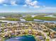 Bright aerial view of a waterfront home in a vibrant community with a lake view at 4809 11Th Avenue E Cir, Bradenton, FL 34208