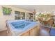 Inviting back patio featuring a hot tub and outdoor seating area, creating a private oasis for relaxation at 4809 11Th Avenue E Cir, Bradenton, FL 34208
