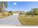 Single-story home featuring a well-manicured lawn and a paved driveway at 4809 11Th Avenue E Cir, Bradenton, FL 34208