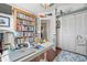 Bright home office features a large bookcase, desk, and a closet at 4809 11Th Avenue E Cir, Bradenton, FL 34208