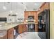 Kitchen features granite countertops, wooden cabinetry and black appliances at 4809 11Th Avenue E Cir, Bradenton, FL 34208