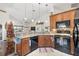 Cozy kitchen featuring wooden cabinetry, granite countertops, and modern appliances at 4809 11Th Avenue E Cir, Bradenton, FL 34208