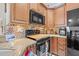 Kitchen featuring modern appliances, wood cabinets, and neutral countertops at 4809 11Th Avenue E Cir, Bradenton, FL 34208