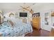 Comfortable main bedroom with hardwood floors, modern ceiling fan and stylish nautical-themed decor at 4809 11Th Avenue E Cir, Bradenton, FL 34208