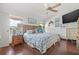 Bright bedroom features nautical décor, wood floors, a ceiling fan and a view of the water at 4809 11Th Avenue E Cir, Bradenton, FL 34208