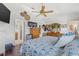 This bright bedroom features an en-suite bathroom, wood floors, and a ceiling fan at 4809 11Th Avenue E Cir, Bradenton, FL 34208
