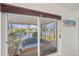 Relaxing sunroom view showcasing a hot tub overlooking a serene lake at 4809 11Th Avenue E Cir, Bradenton, FL 34208