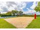 Community sand volleyball court surrounded by lush landscaping and the tennis court at 4809 11Th Avenue E Cir, Bradenton, FL 34208