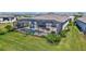 Wide aerial shot showcasing multiple homes with pools and screened patios in a well-planned community at 4968 Seafoam Trl, Bradenton, FL 34211