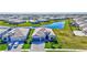 Beautiful aerial view of a home with a three-car garage, lush landscaping, and a paver driveway at 4968 Seafoam Trl, Bradenton, FL 34211