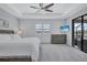 Bright and airy bedroom features a ceiling fan, a TV, and a glass door leading to the lanai at 4968 Seafoam Trl, Bradenton, FL 34211
