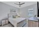 Comfortable bedroom with a ceiling fan, white bedding, natural light, and coastal decor at 4968 Seafoam Trl, Bradenton, FL 34211