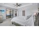 Primary bedroom features access to the lanai, a ceiling fan, and is decorated in calming, neutral tones at 4968 Seafoam Trl, Bradenton, FL 34211