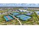 Aerial view of community amenities featuring tennis courts, basketball court, clubhouse, and pool area at 4968 Seafoam Trl, Bradenton, FL 34211