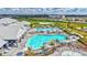 Aerial view of the community pool area, complete with ample seating, a poolside bar, and a splash pad at 4968 Seafoam Trl, Bradenton, FL 34211