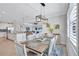 Open-concept dining room is adjacent to the kitchen and living room, with a rustic wood table and an eye-catching light fixture at 4968 Seafoam Trl, Bradenton, FL 34211