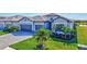 Attractive home exterior showcasing lush landscaping, paver driveway, and a three-car garage at 4968 Seafoam Trl, Bradenton, FL 34211