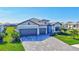 Stunning exterior view of a well-maintained home with a three-car garage and a paver driveway at 4968 Seafoam Trl, Bradenton, FL 34211