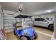 Spacious garage featuring a blue golf cart and a silver pickup truck, offering ample parking and storage at 4968 Seafoam Trl, Bradenton, FL 34211