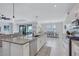 Bright open kitchen boasts stainless appliances, island with seating, and seamless flow to the dining and living areas at 4968 Seafoam Trl, Bradenton, FL 34211