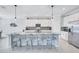 Modern kitchen with a large center island, white cabinets, pendant lighting, and tile floors at 4968 Seafoam Trl, Bradenton, FL 34211