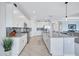 Well-equipped kitchen with white cabinetry, a large island, and stainless steel appliances at 4968 Seafoam Trl, Bradenton, FL 34211