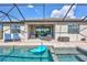 Covered patio with elegant outdoor seating near the pool and hot tub, ideal for relaxation and entertaining at 4968 Seafoam Trl, Bradenton, FL 34211