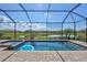 Screened-in pool area offers a serene view with a hot tub and lush landscaping for outdoor enjoyment at 4968 Seafoam Trl, Bradenton, FL 34211