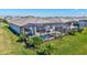 Aerial view of a home featuring a screened-in pool, patio, and well-kept lawn with landscaped borders at 4968 Seafoam Trl, Bradenton, FL 34211