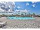 Inviting community pool area with lounge chairs and umbrellas on a sunny day at 4968 Seafoam Trl, Bradenton, FL 34211