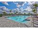 Inviting community lap pool with lounge chairs and umbrellas on a sunny day at 4968 Seafoam Trl, Bradenton, FL 34211