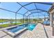 Screened-in pool area features a spa with relaxing views of the backyard and pond at 4968 Seafoam Trl, Bradenton, FL 34211