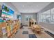 Community playroom featuring toys, tv, play house, table and chairs and view of gym at 4968 Seafoam Trl, Bradenton, FL 34211
