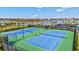 Aerial view of community tennis courts with views of the water and surrounding neighborhood at 4968 Seafoam Trl, Bradenton, FL 34211