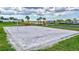 Well-maintained sand volleyball court surrounded by lush landscaping and a blue sky at 4968 Seafoam Trl, Bradenton, FL 34211
