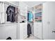 Modern walk-in closet featuring custom white shelving, hanging racks, and convenient drawer storage at 4968 Seafoam Trl, Bradenton, FL 34211