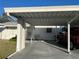 Carport view of a single story home, with neutral paint, yellow shutter accents, and well maintained front yard at 6024 Arlene Way, Bradenton, FL 34207