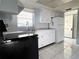 Clean kitchen featuring white cabinets, stainless steel appliances, and durable tile flooring at 6024 Arlene Way, Bradenton, FL 34207