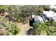 An aerial view of home, highlighting its proximity to lush greenery, pool, and landscaping at 617 35Th W St, Bradenton, FL 34205