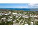 An aerial view showcases the property within a neighborhood near a body of water and recreational fields at 617 35Th W St, Bradenton, FL 34205