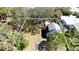 An aerial view with property lines, highlighting its proximity to lush greenery, pool, and landscaping at 617 35Th W St, Bradenton, FL 34205