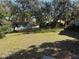 Large backyard with grass and several mature trees at 617 35Th W St, Bradenton, FL 34205