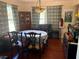 Elegant dining room featuring a beautiful chandelier, complemented by classic furniture and ample natural light at 617 35Th W St, Bradenton, FL 34205