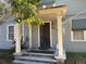 Inviting front porch featuring classic architectural details, enhancing the home's charming facade and appeal at 617 35Th W St, Bradenton, FL 34205