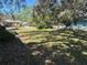 Landscaped front yard offering shade from mature trees and a view of neighboring homes at 617 35Th W St, Bradenton, FL 34205
