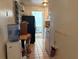 Hallway with tile flooring leading to the kitchen and other rooms at 617 35Th W St, Bradenton, FL 34205