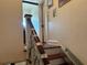 Interior staircase with wooden handrail and steps, leading upwards to other floor at 617 35Th W St, Bradenton, FL 34205