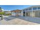Charming outdoor space featuring a wooden pergola, outdoor seating, and seamless access to the interior living area at 619 Buttonwood Dr, Longboat Key, FL 34228