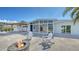 A stunning view of the back patio with a fire pit and an open concept leading to the great room at 619 Buttonwood Dr, Longboat Key, FL 34228